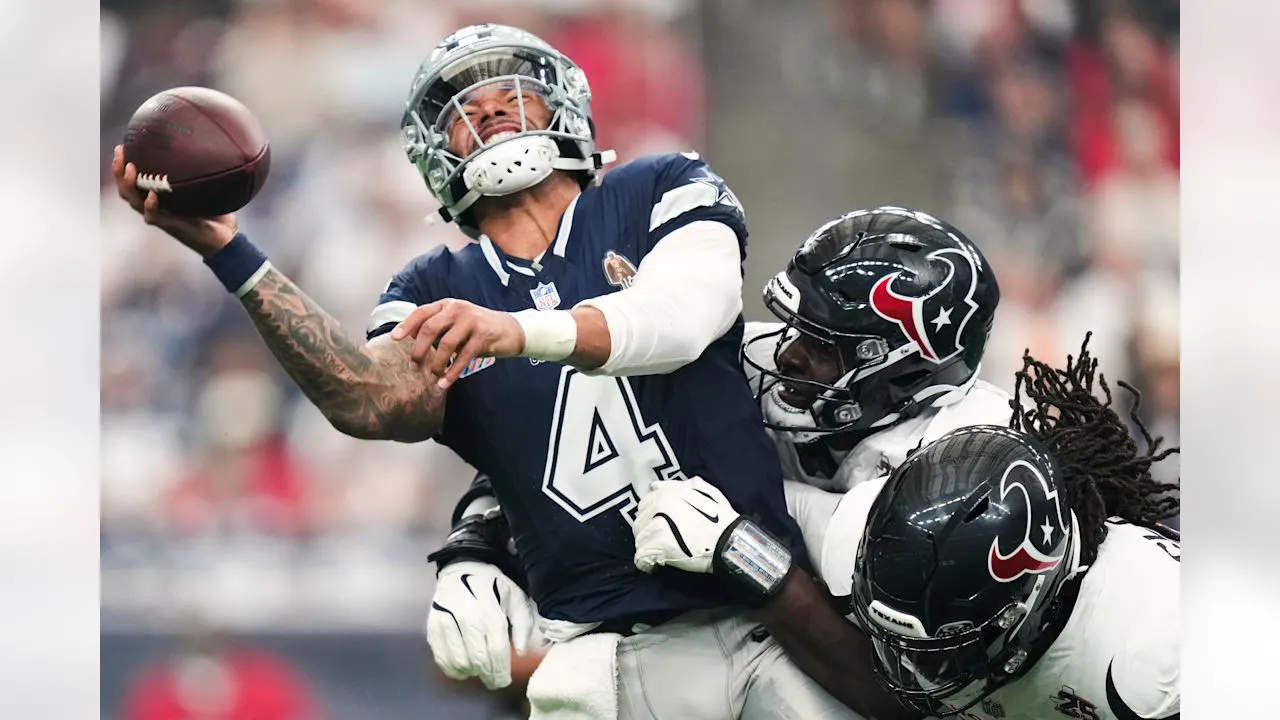 Dallas Cowboys quarterback Dak Prescott (4) is hit by Houston Texans defensive ends Will Anderson Jr., center, and, Jadeveon Clowney, right, during the first half of an NFL football game in Houston, Sunday, Oct. 4, 2026.