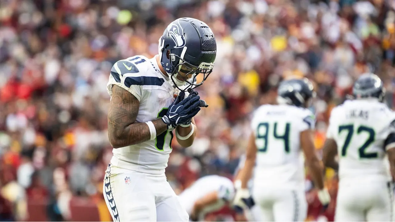 Seahawks receiver Jaxon Smith-Njigba bows after scoring his second touchdown of the game.