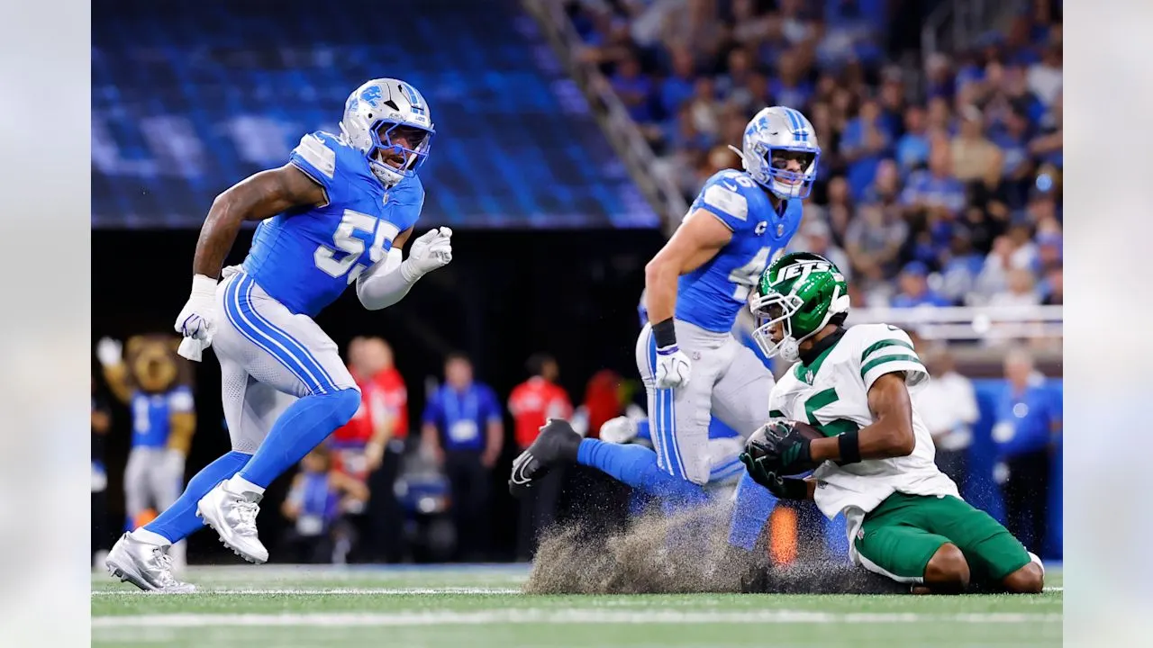 New York Jets' Garrett Wilson catches a pass in front of Detroit Lions' Derrick Barnes and Jack Campbell during the first half of an NFL football game in Detroit, Sunday, Sept. 27, 2026.